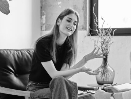 Young smiling girl patient in therapy session with social mental therapist